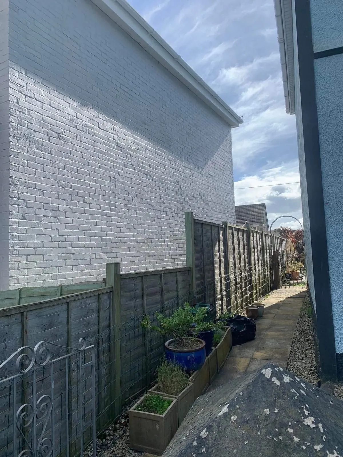 Freshly painted brick wall after preparation and masonry paint in Port Isaac